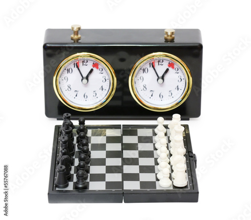 Chess timer and chess board with figures isolated on white photo