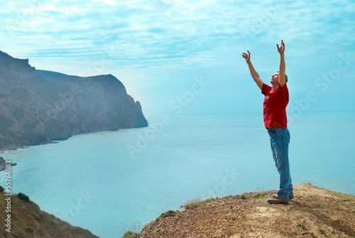 Happy man on the cliff