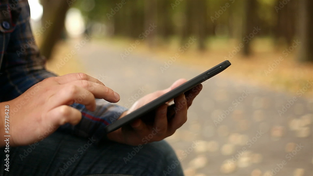 Young man working on tablet computer in city park, 1080p Young man working on tablet computer in city park, 1080p