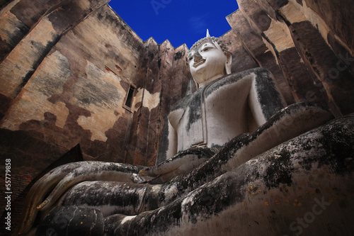 Large buddha statue against blue sky at wat Srichum photo