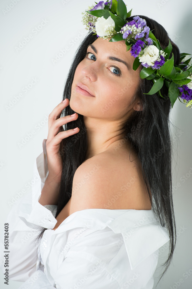 Beautiful woman wearing wreath of flowers