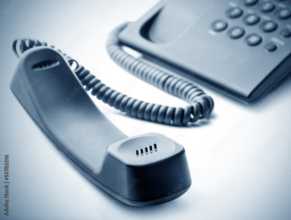 Modern call phone with cord in office Modern call phone with cord in office