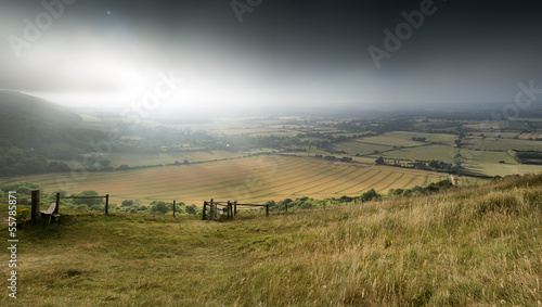 View across English countryside landscape during late Summer eve