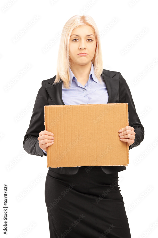 Sad young businesswoman holding a piece of cardboard Sad young businesswoman holding a piece of cardboard