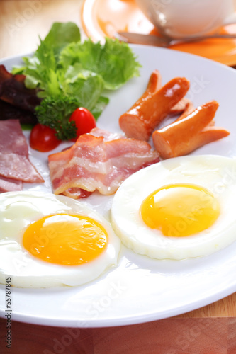 breakfast with egg, ham, bacon, sausage and vegetables
