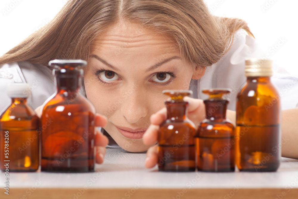 woman doctor with medication in glass bottles woman doctor with medication in glass bottles