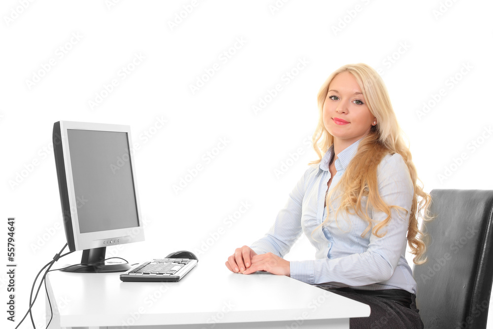 Young cute girl behind a desk with a computer and a monitor Young cute girl behind a desk with a computer and a monitor