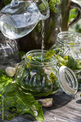 Preserving fresh cucumbers in a jar in the countryside