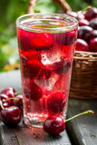 Close-up of sweet cherries juice with ice cubes