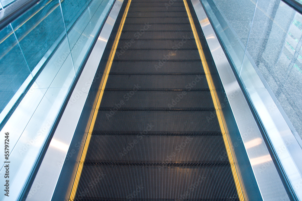 Moving escalator in an airport Moving escalator in an airport