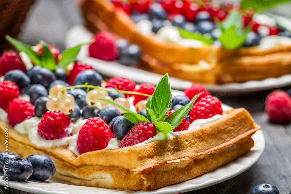 Closeup of waffels with cream and berry fruits Closeup of waffels with cream and berry fruits