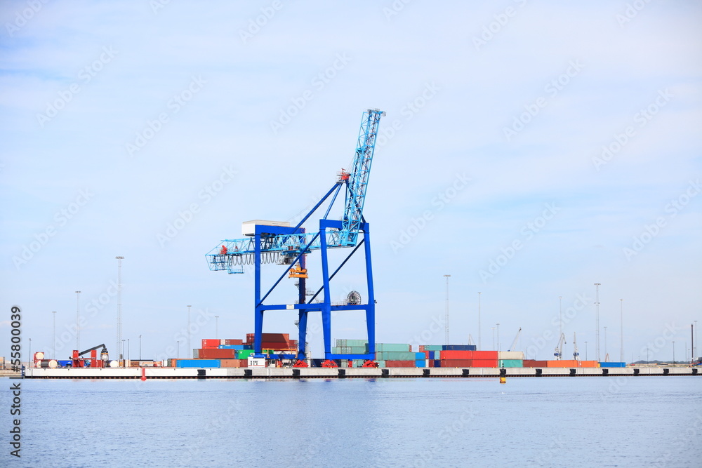 Port cargo crane and container over blue sky