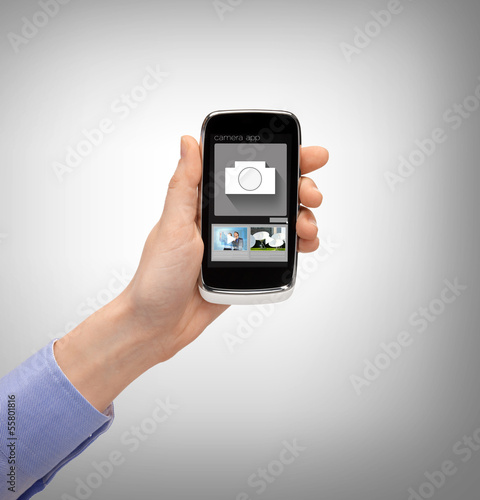 Wallpaper Mural hand with smartphone showing application Torontodigital.ca