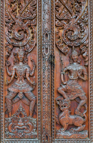 Native Thai style carving, painting on church door in the temple