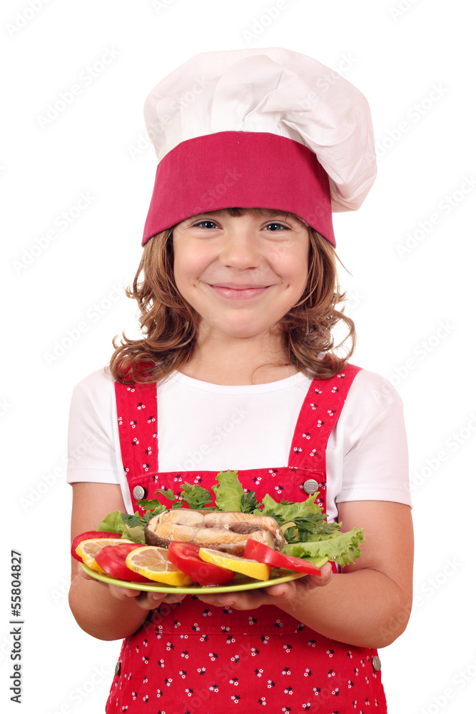 happy little girl cook holding dish with salmon seafood