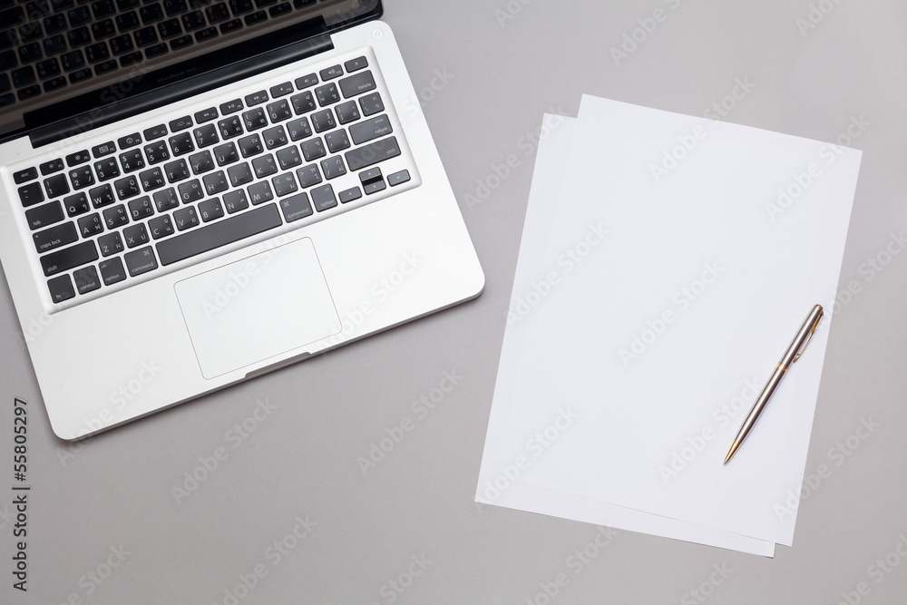 blank paper and laptop on table blank paper and laptop on table