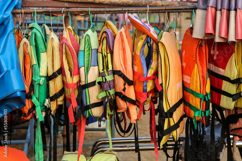 Old colorful life jackets for rent.