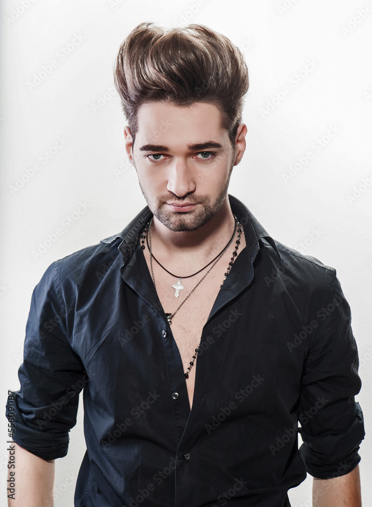 young male fashion model posing in a casual outfit young male fashion model posing in a casual outfit
