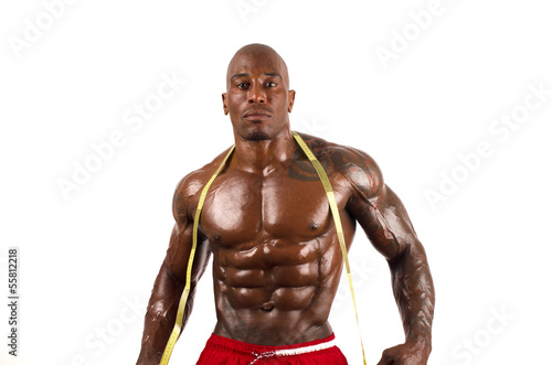 Black bodybuilder taking measurements of his big muscles