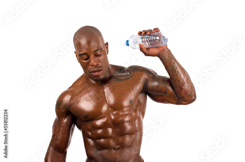 Black bodybuilder pouring cold water on himself to cool down