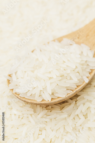 Uncooked white rice on spoon