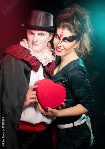 man and woman  wearing  as  vampire and witch. Halloween photo