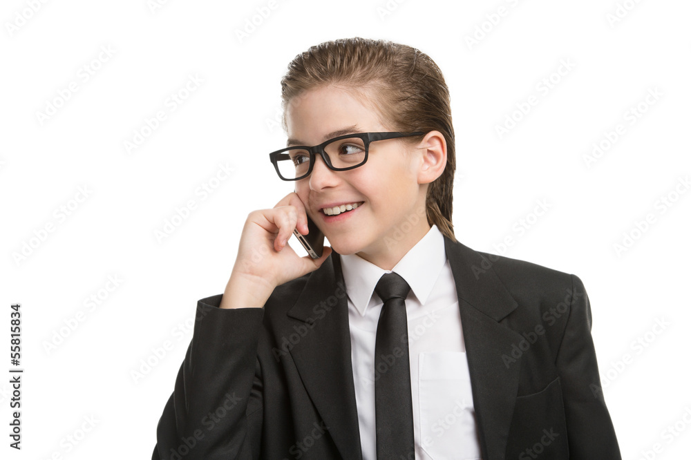 Little businessman on the phone. Cheerful little boy in formalwe