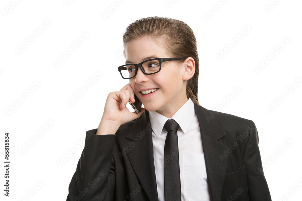 Little businessman on the phone. Cheerful little boy in formalwe Little businessman on the phone. Cheerful little boy in formalwe