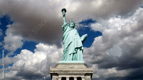 Statue of Liberty wide shot with moving cloud time lapse.