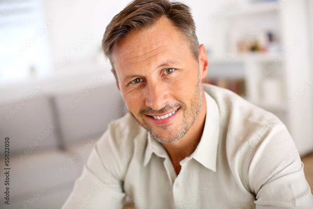 Attractive smiling man relaxing at home Attractive smiling man relaxing at home