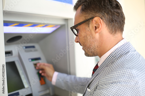 Man withdrawing money from ATM machine