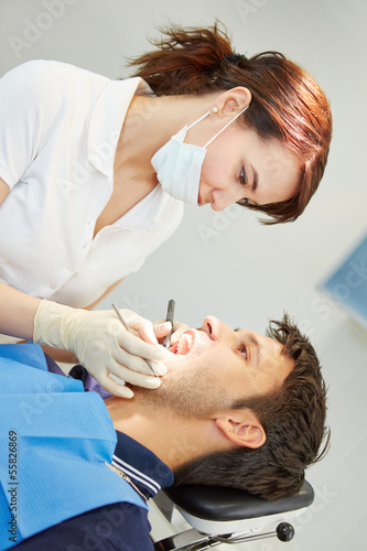 Dental assistant with male patient