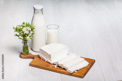 milk bottle and glass on wooden background photo