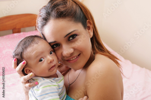 Portrait of a beautiful hispanic happy mother with smiling baby