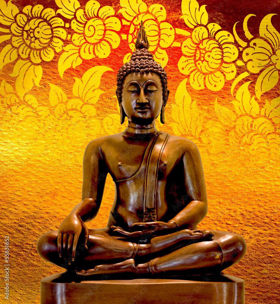 Fototapeta premium Buddha statue on a gold background.