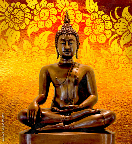Buddha statue on a gold background.