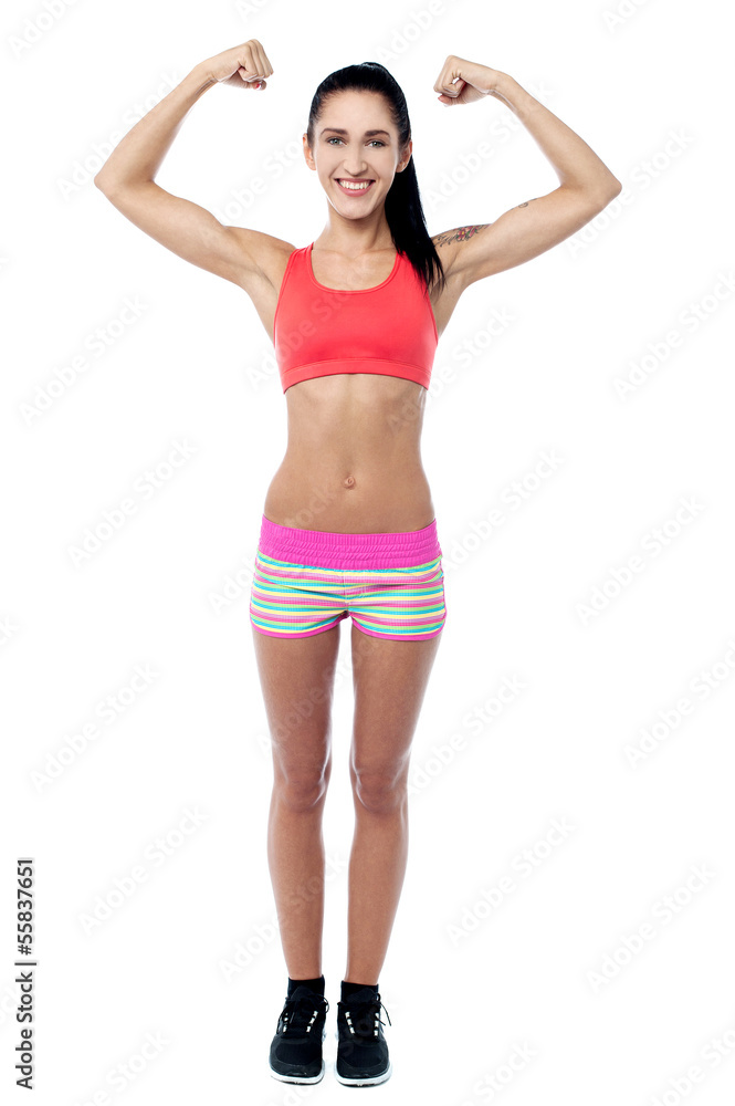 Female trainer showing her biceps Female trainer showing her biceps