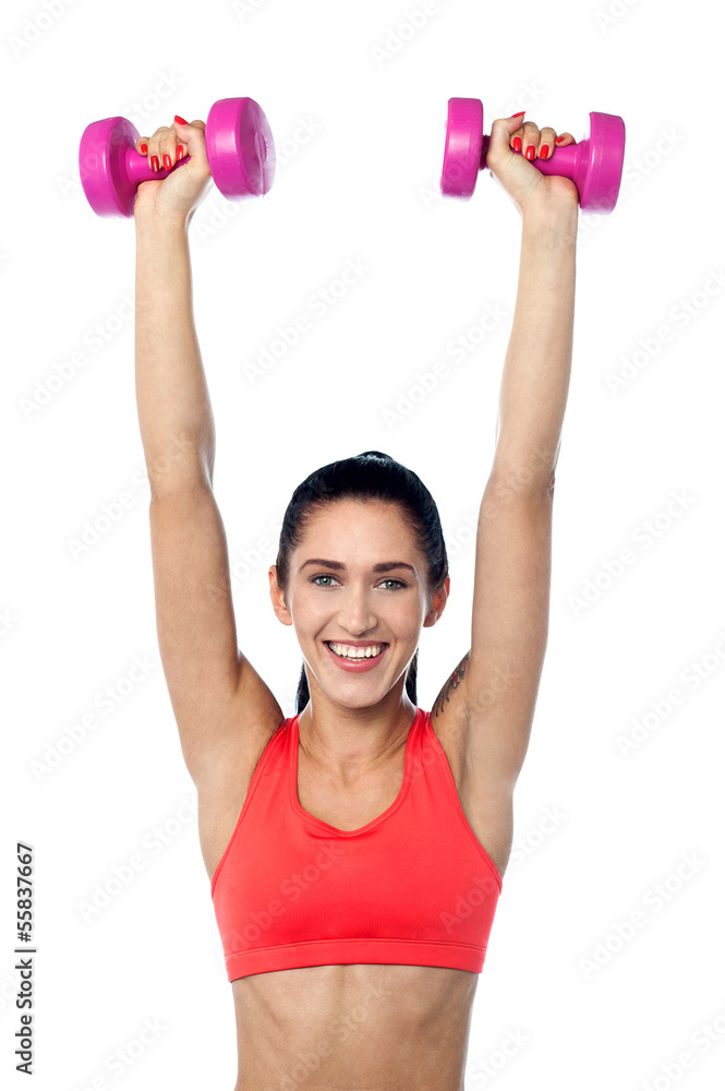 Happy fitness woman lifting dumbbells Happy fitness woman lifting dumbbells