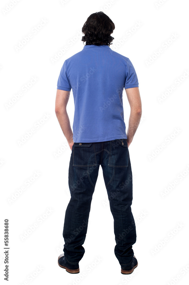 Casual young man facing the wall Casual young man facing the wall