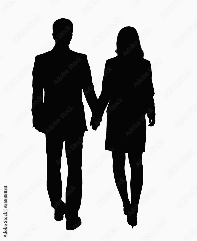 Silhouette of businessman and businesswoman holding hands. Silhouette of businessman and businesswoman holding hands.