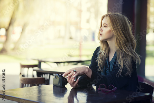 beautiful young girl resting in a cafe photo