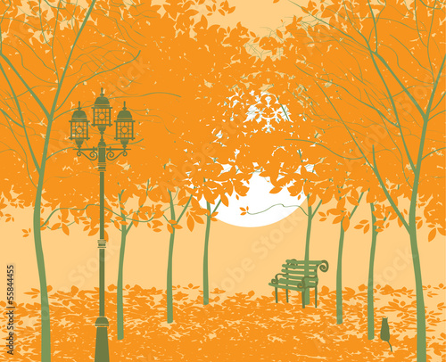 autumn park landscape with lantern and bench at sunset