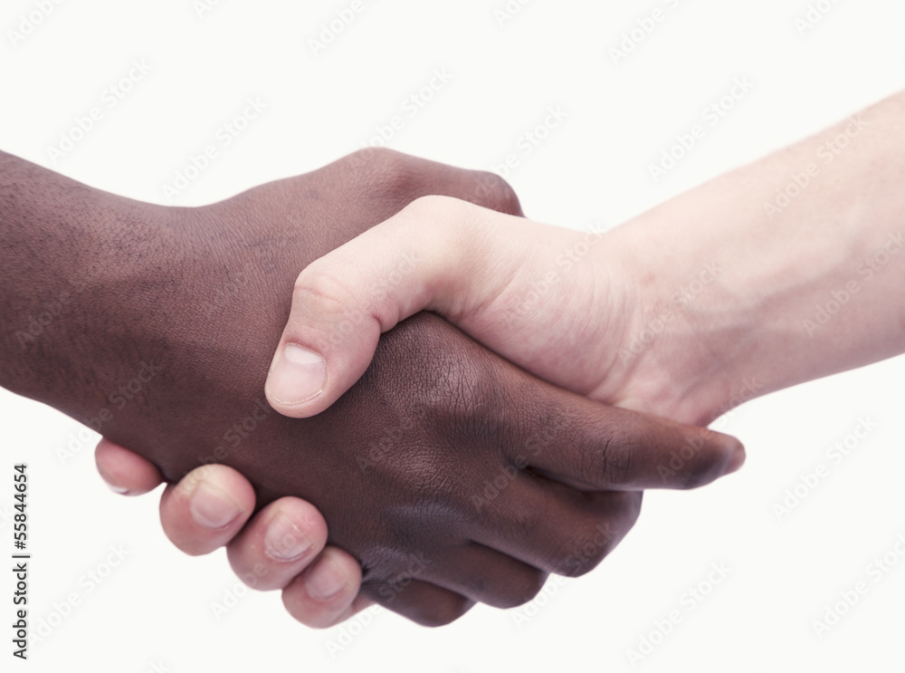 Two young men shaking hands, close-up, studio shot Two young men shaking hands, close-up, studio shot