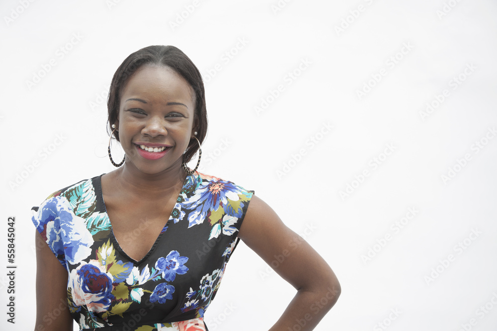 Portrait of young smiling woman with hand on hip in traditional clothing from Africa, studio shot Portrait of young smiling woman with hand on hip in traditional clothing from Africa, studio shot