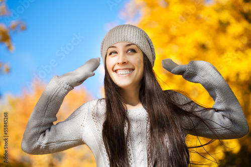 cheerfu woman on a autumn sky background photo