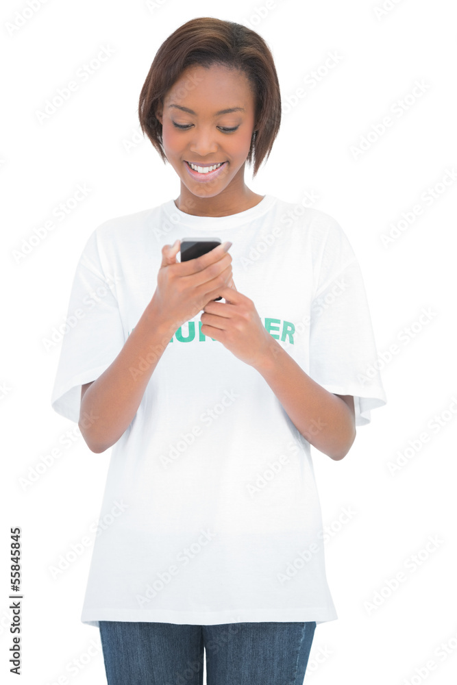 Cheerful volunteer woman looking at her mobile phone Cheerful volunteer woman looking at her mobile phone