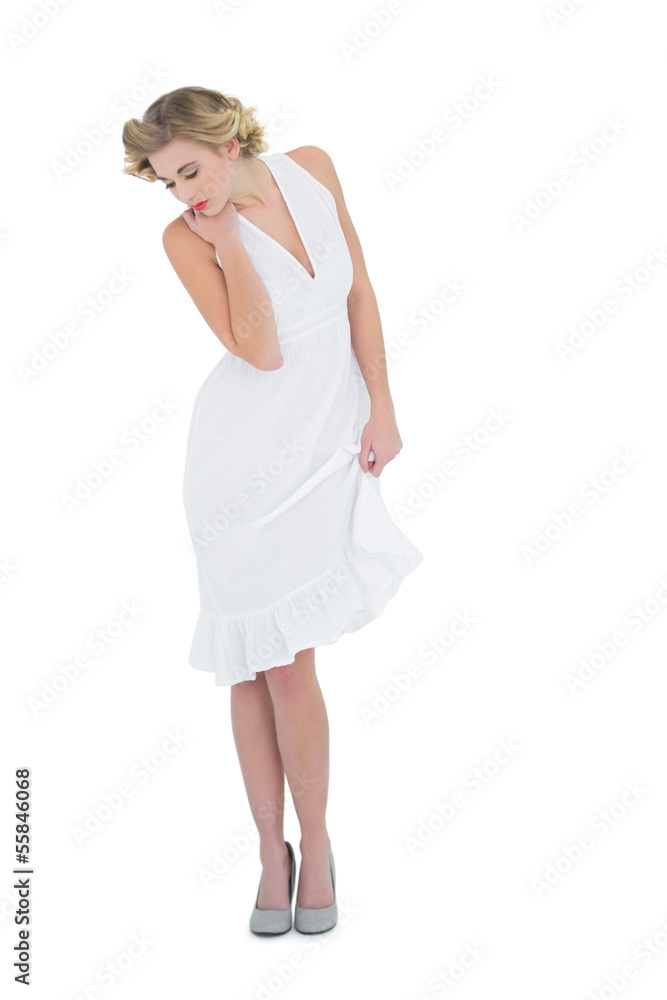 Cute fashion blonde model posing looking down Cute fashion blonde model posing looking down
