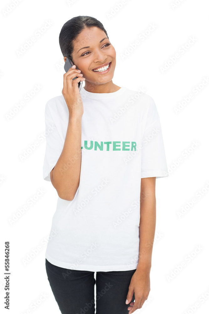 Smiling model wearing volunteer tshirt having a phone call Smiling model wearing volunteer tshirt having a phone call