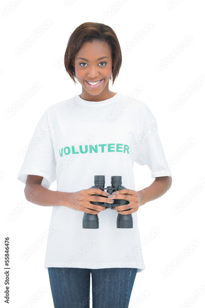 Smiling woman looking at camera and holding binoculars Smiling woman looking at camera and holding binoculars