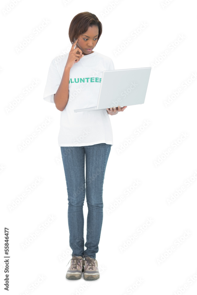 Thoughtful volunteer woman looking at her laptop Thoughtful volunteer woman looking at her laptop